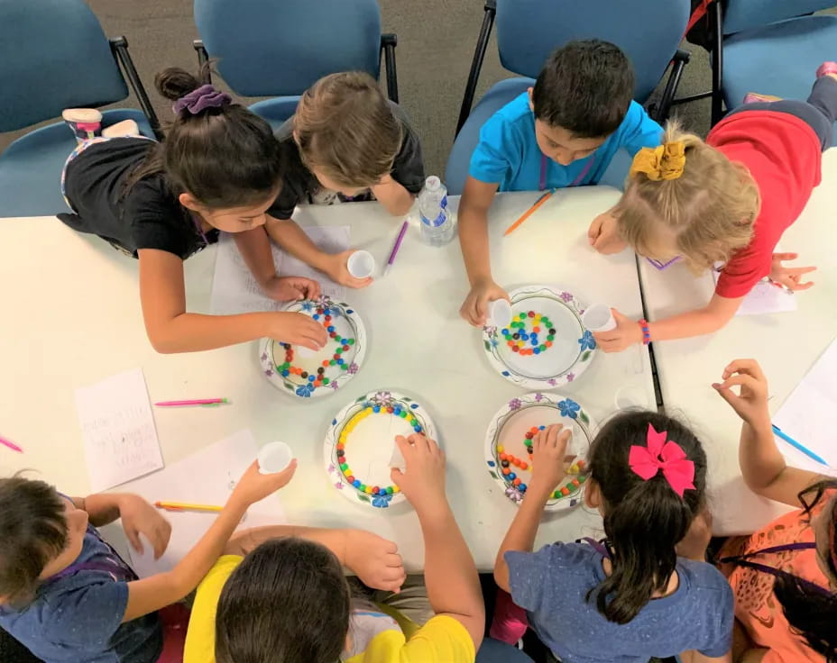 a group of children eating at a table