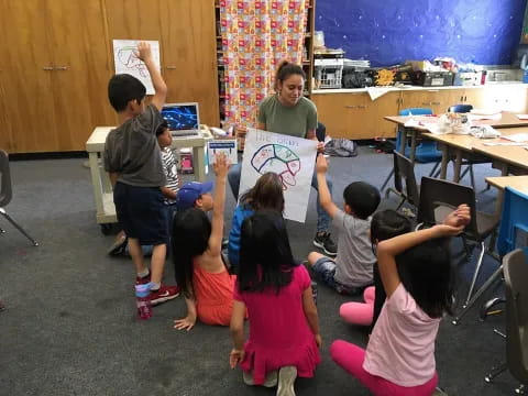 a group of children holding up a piece of paper