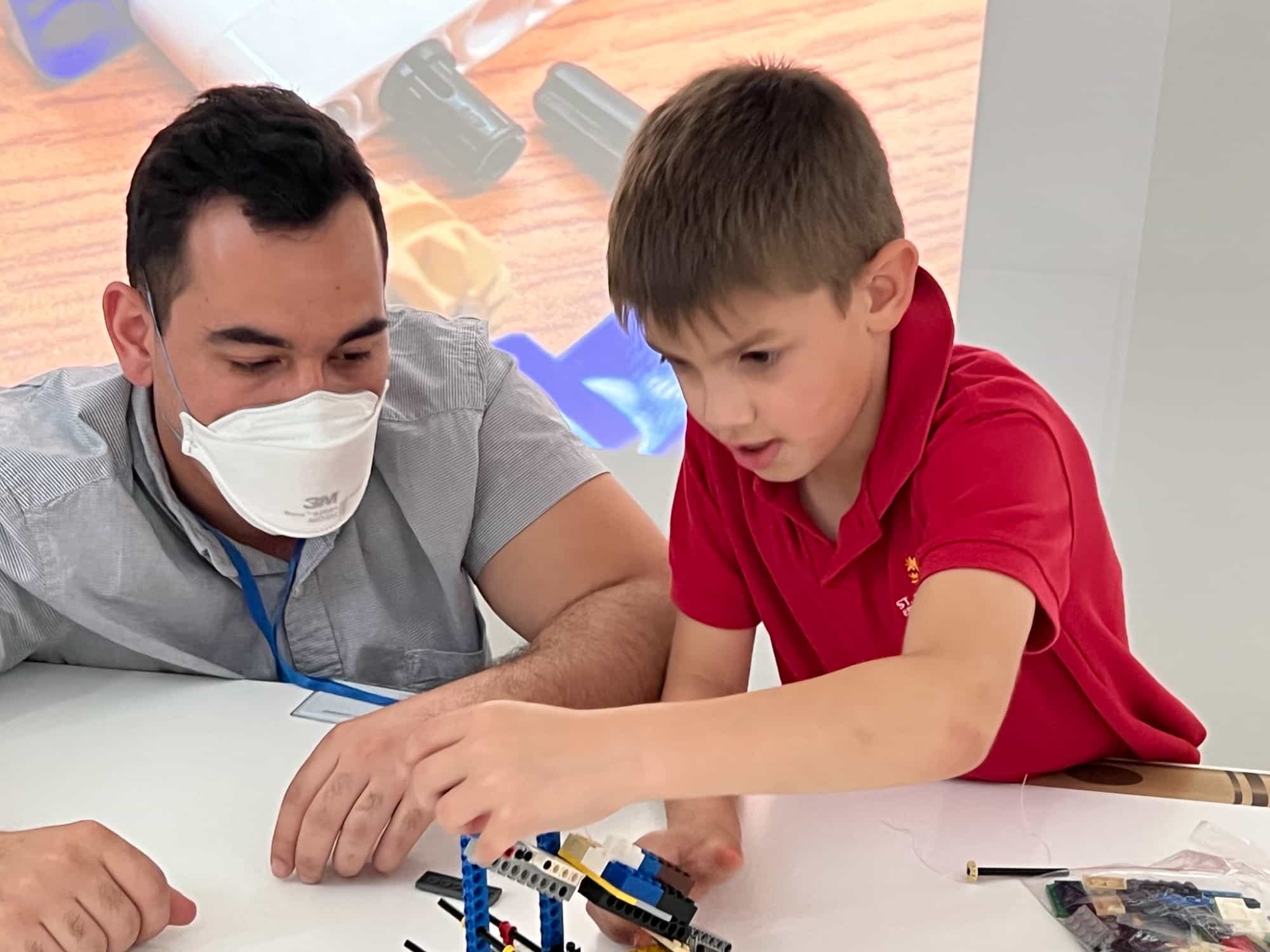 a man and a boy looking at a paper