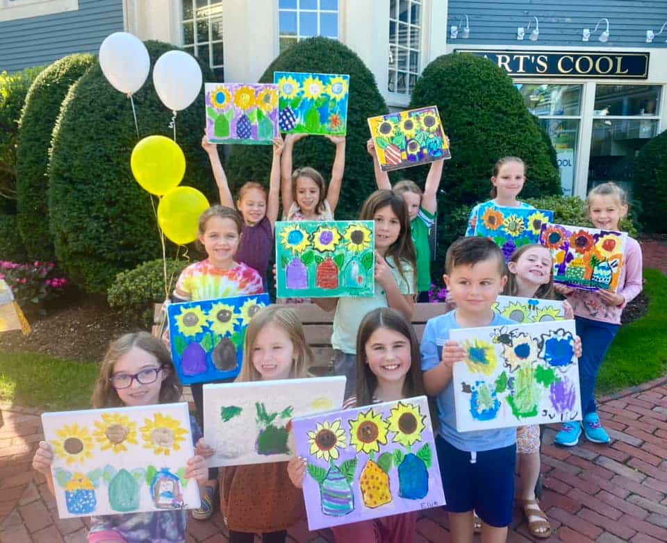 a group of children holding balloons