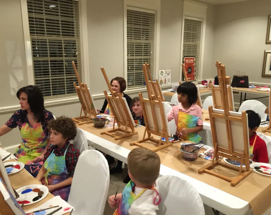 a group of children sitting at a table