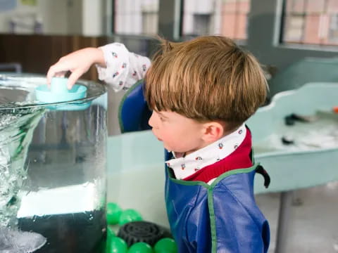 a child looking at a fish tank