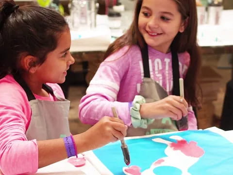 a few young girls painting