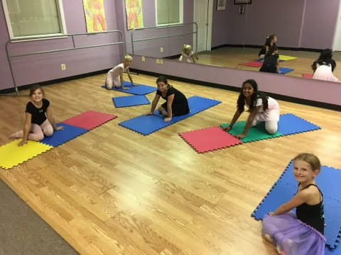 a group of people sitting on mats