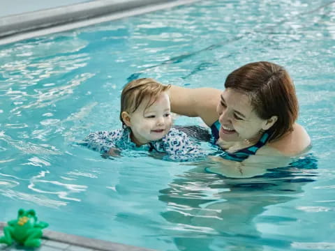 a man and a child in a pool