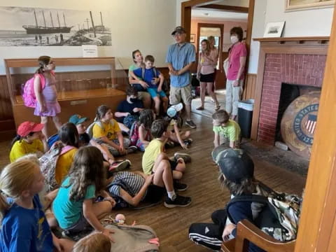 a group of children sitting in a room