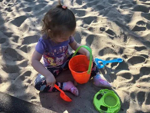 a baby playing in the sand