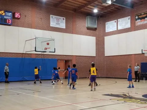 a group of kids playing basketball