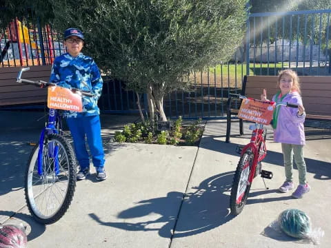 a boy and girl on bicycles