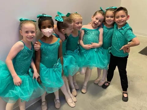 a group of girls in green dresses