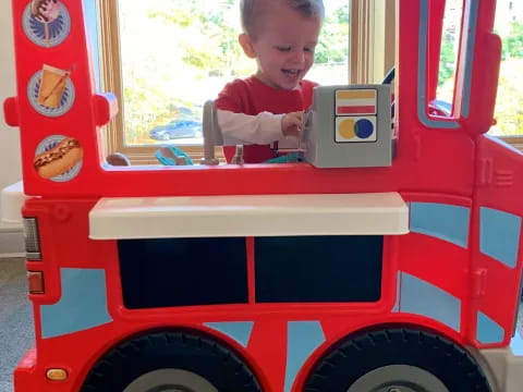 a child in a toy fire truck