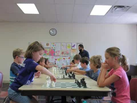 a group of people playing chess