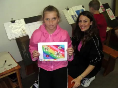 a boy and girl holding a picture