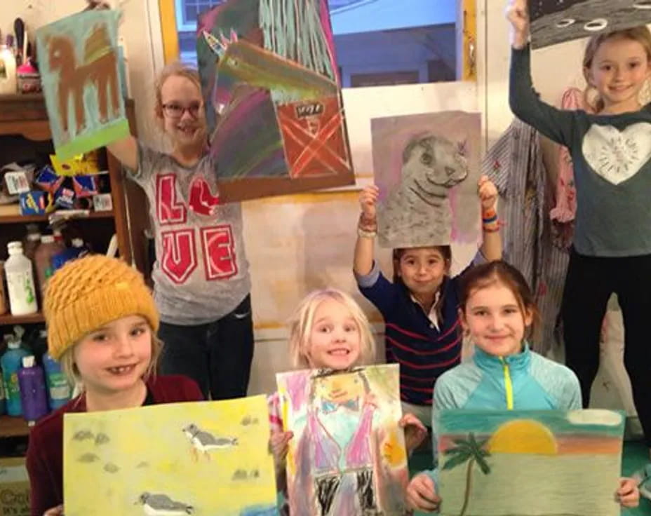 a group of people holding up colorful paper