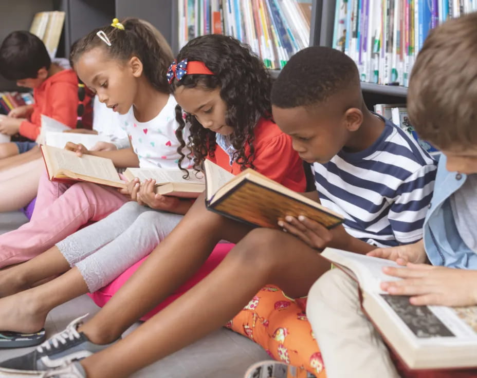 a group of children reading books