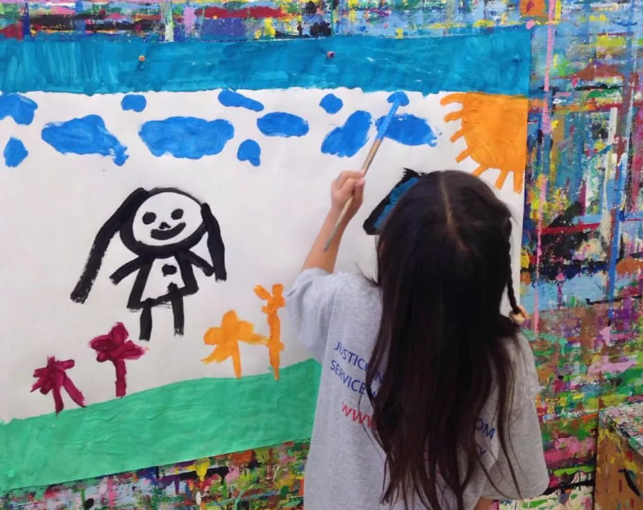 a girl painting on a wall