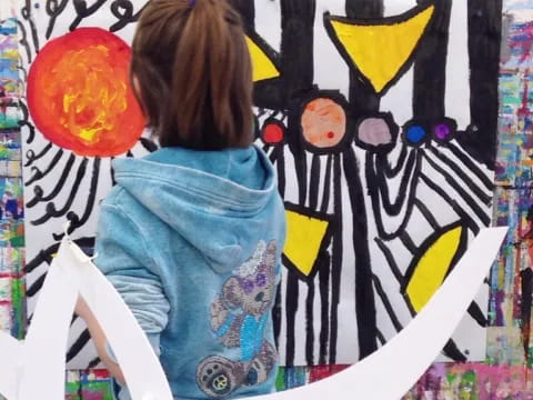 a girl painting on a wall