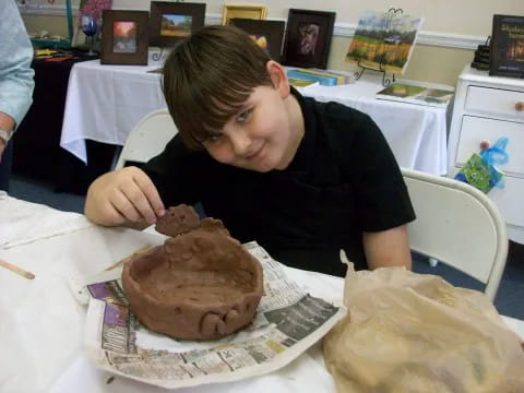 a person sitting at a table with a cake