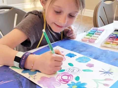 a girl painting on a table