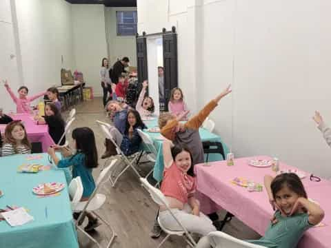 a group of children sitting at tables