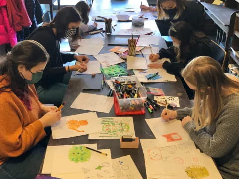 a group of people sitting around a table with papers on it