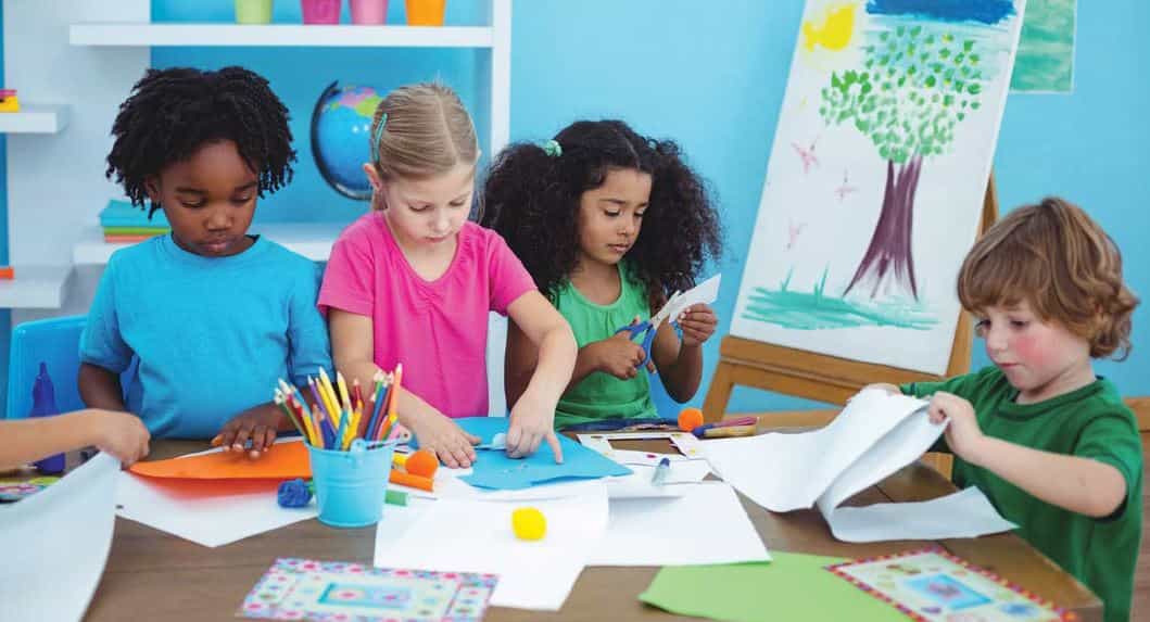 a group of children sitting at a table