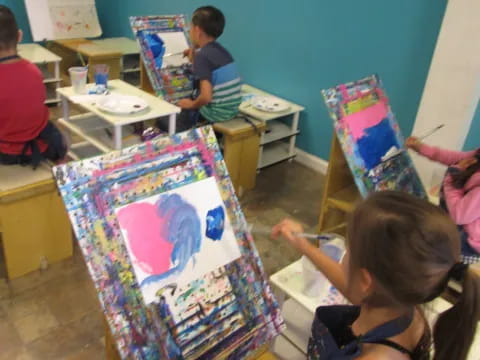 children painting on a canvas