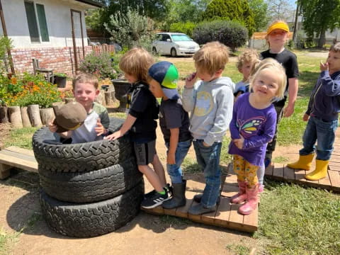 a group of children playing with a statue