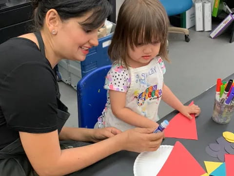 a person and a child painting