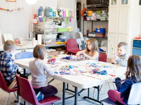 a group of children sitting around a table