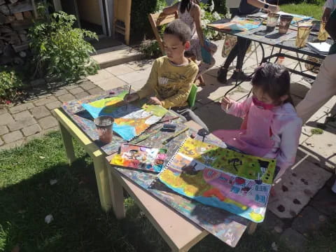 children painting on a table