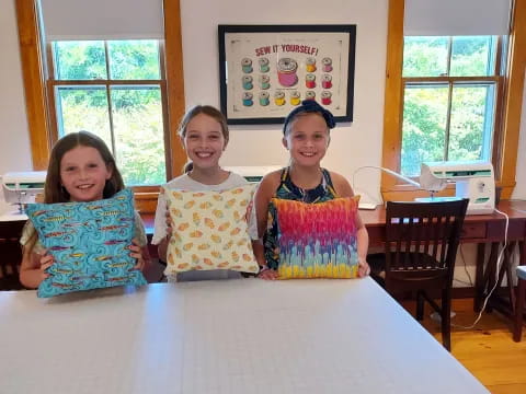 a group of girls sitting at a table