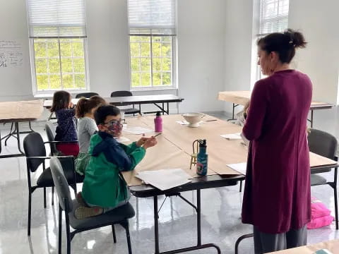 a woman and a child in a classroom