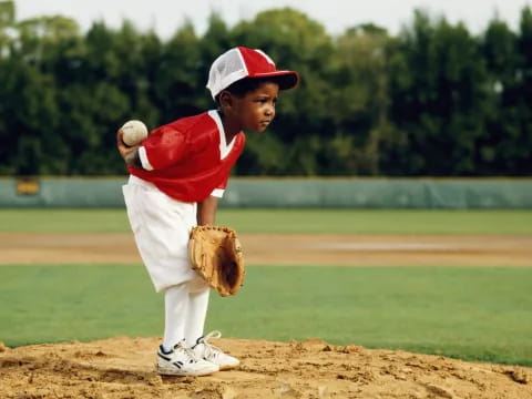 a kid pitching a baseball