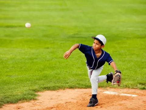 a kid pitching a baseball