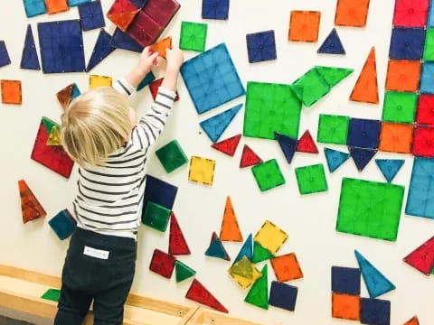 a child painting on a white board