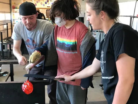 a group of people standing around a table with a machine on it