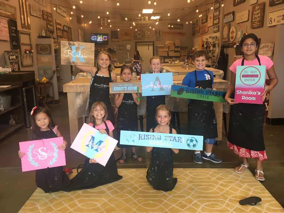 a group of children holding signs