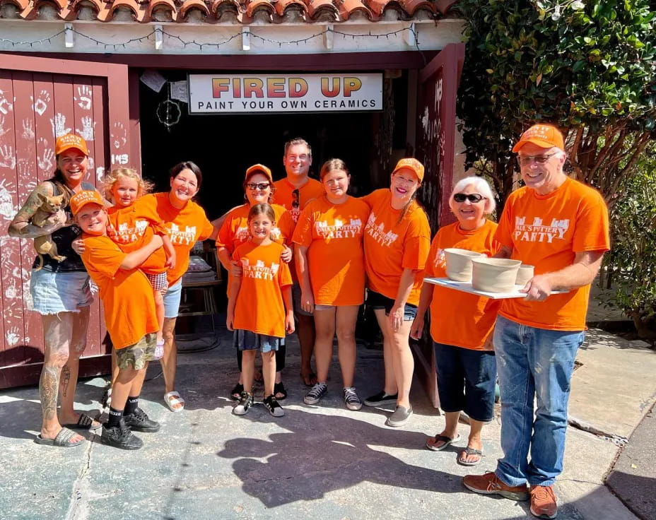 a group of people wearing orange shirts