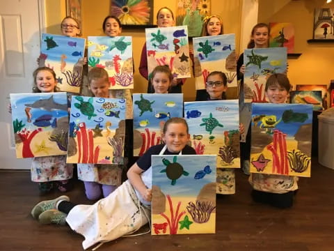 a group of children holding up books