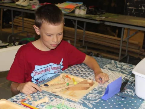 a boy painting on a table