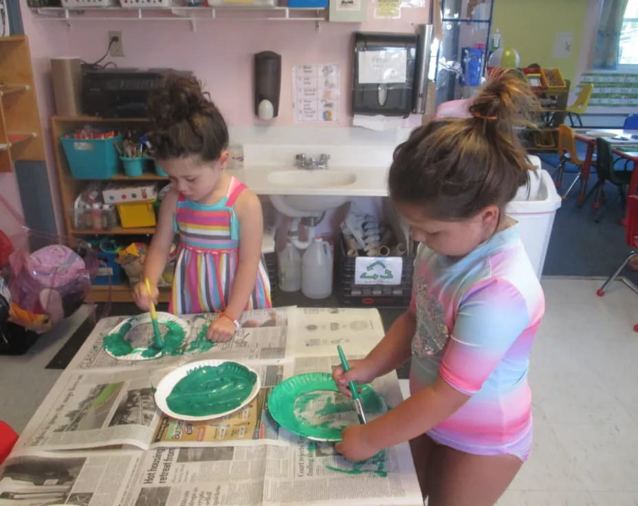 a couple of young girls playing with toys in a room