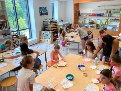 a group of children sitting at a table