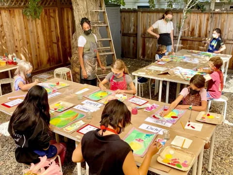 a group of children sitting at a table