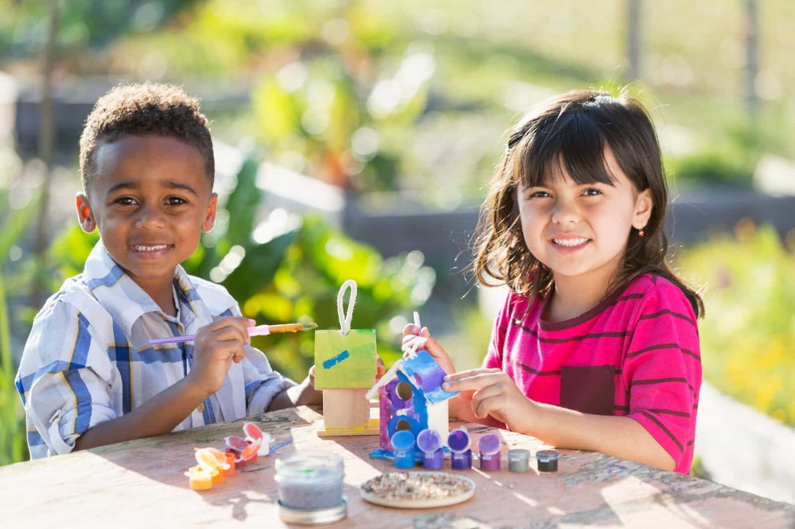 a boy and girl playing with building blocks