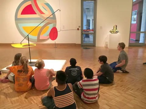 a group of people sitting on the floor