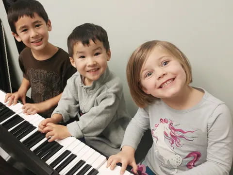 a group of kids playing a piano