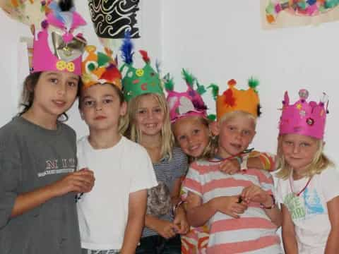 a group of people wearing party hats