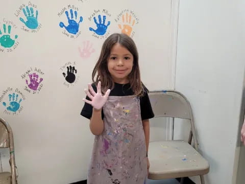 a girl standing in front of a wall with butterflies on it