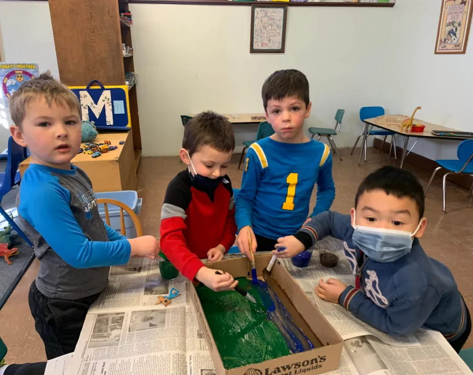 a group of boys sitting at a table